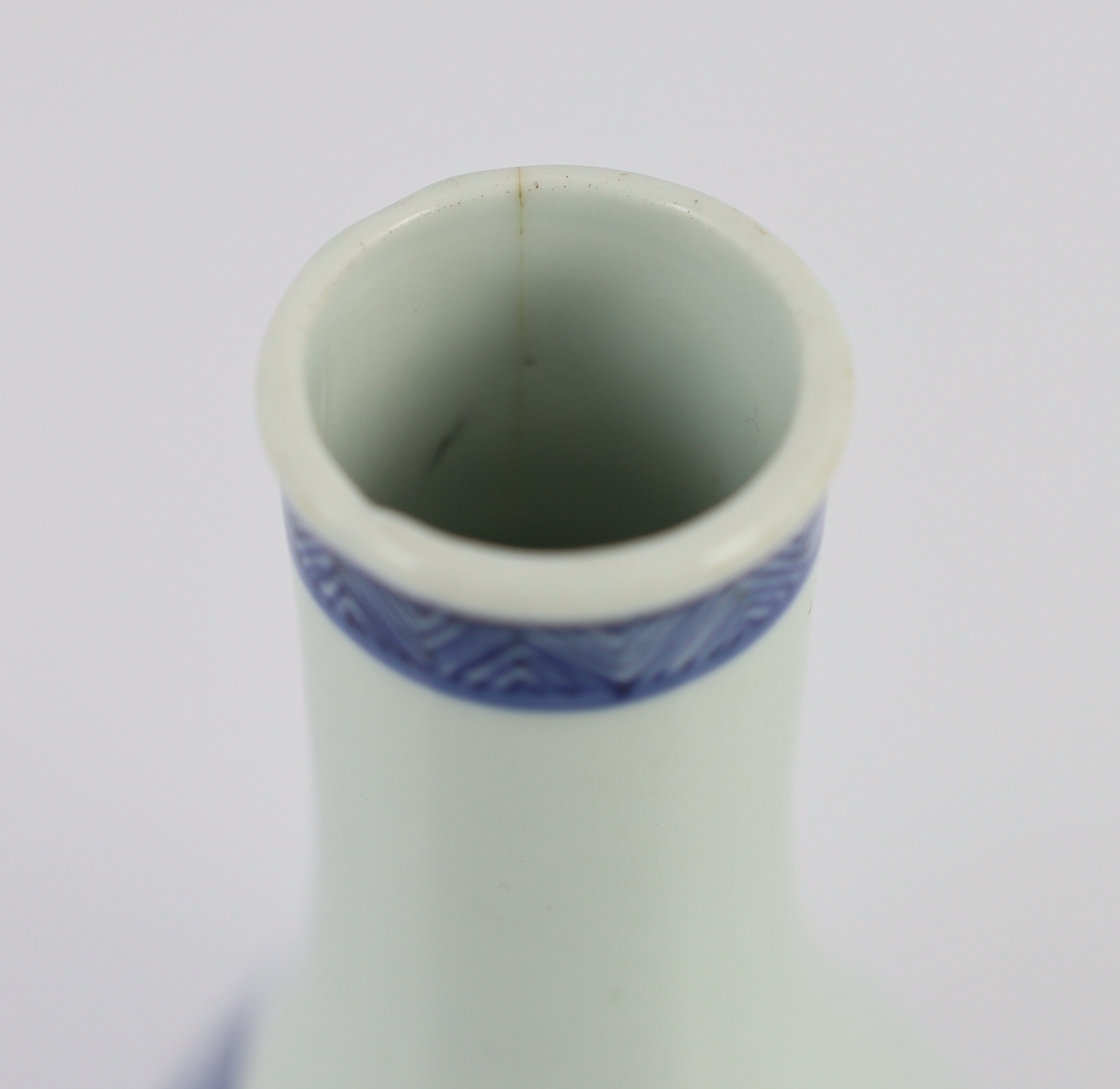 A Chinese blue and white ‘Zhong Kui’ inscribed bottle vase, early Kangxi period, hairline cracks to neck and inside edge of foot